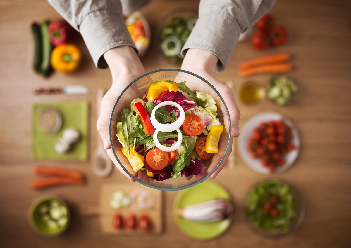 Woman holding bowl of vegetables