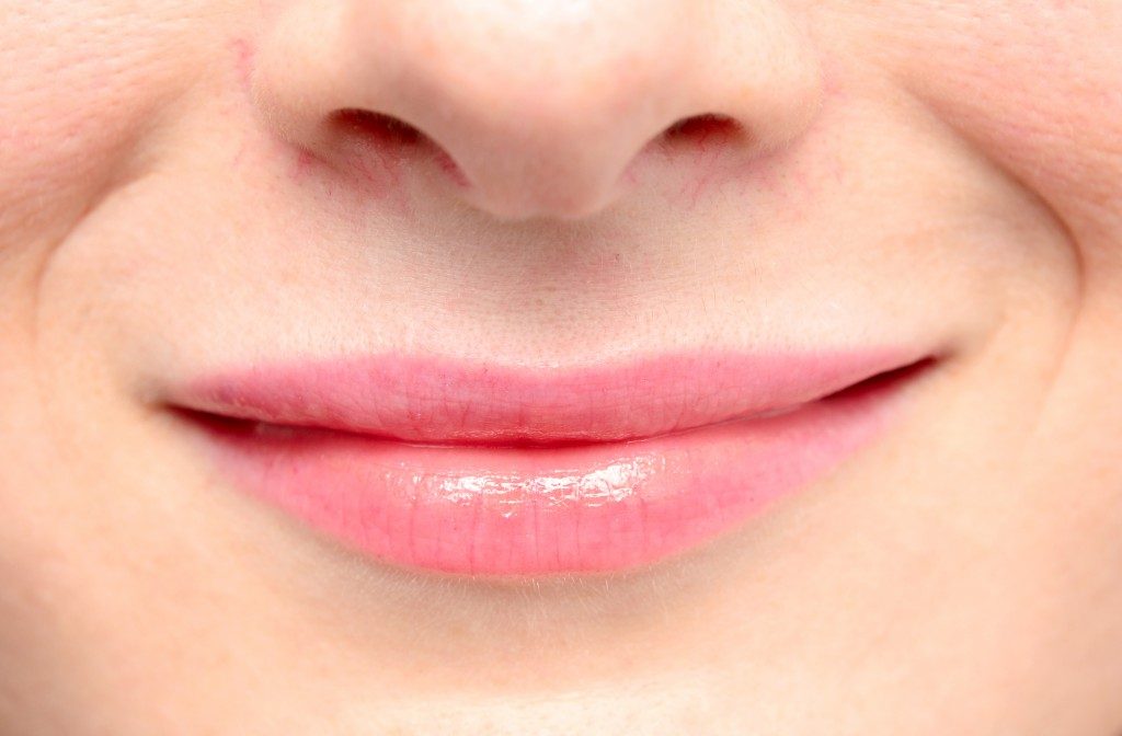 Woman smiling close up on her lips