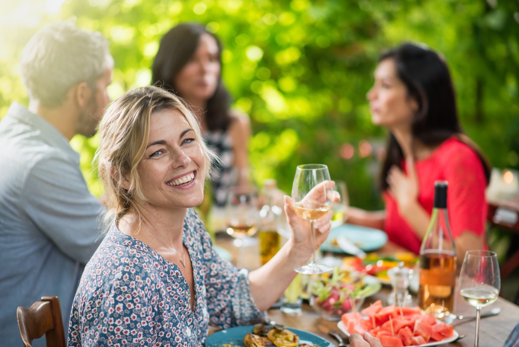 Friends eating on a terrace table outside