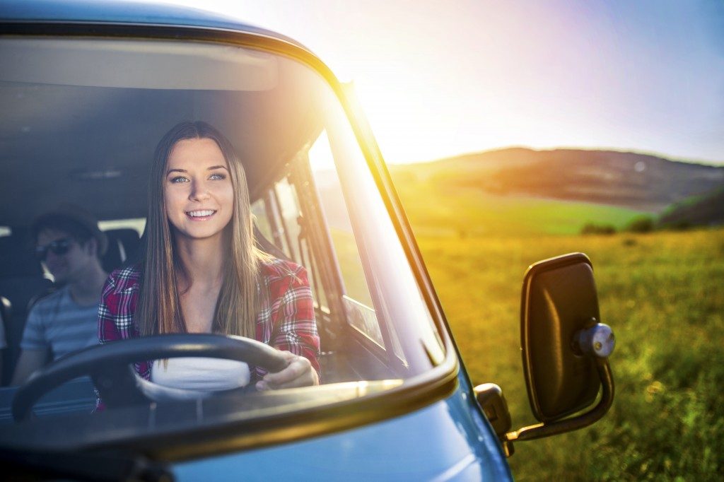 woman smiling while driving van
