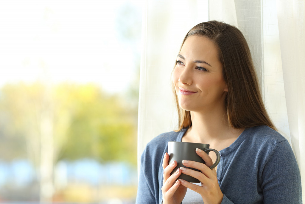 happy woman drinking a cup of coffee