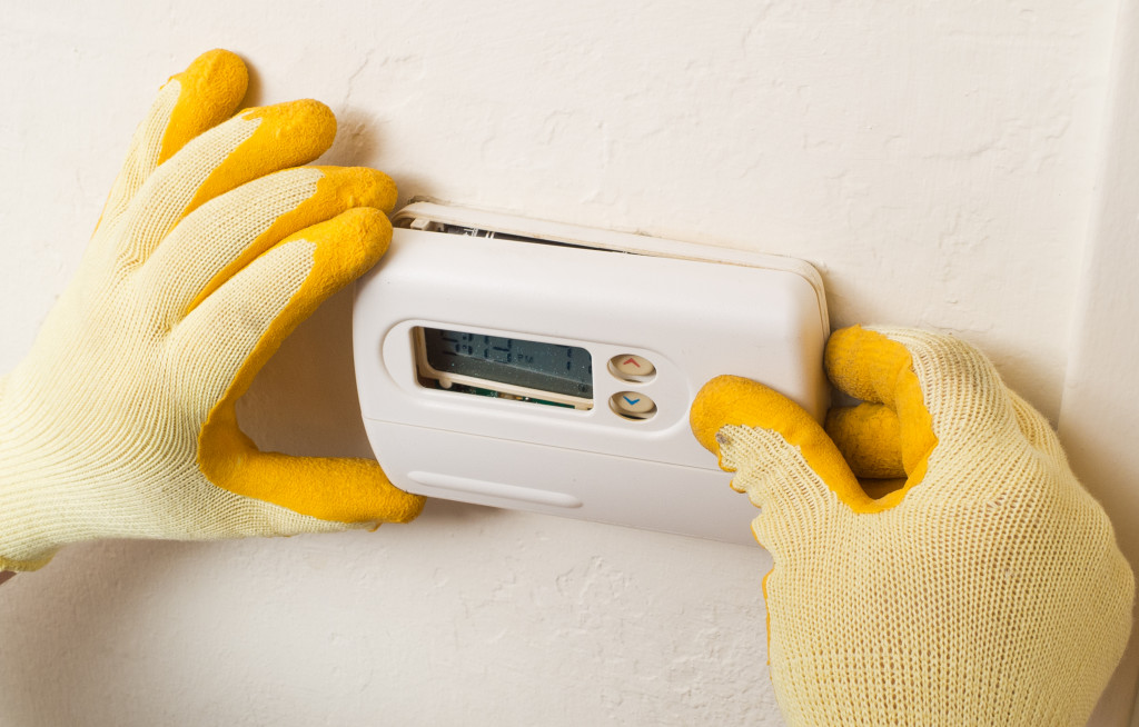 hands installing an hvac system 