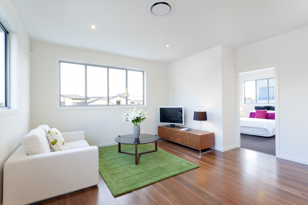 Brightly lit living area of a home with large windows.