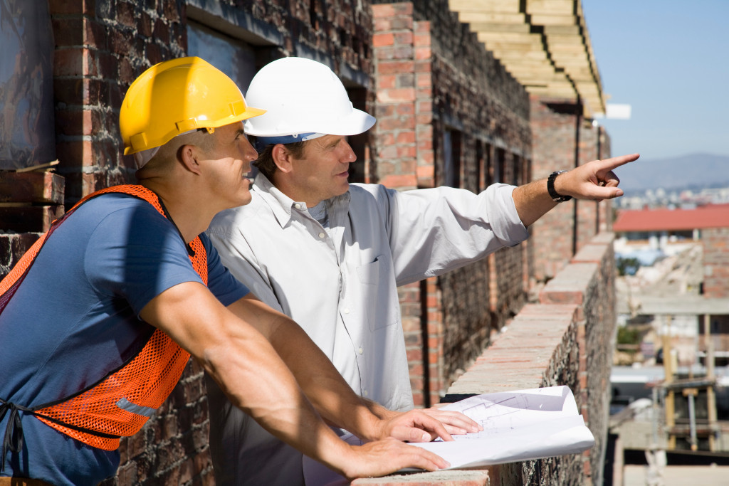 two engineers discussing at the top floor