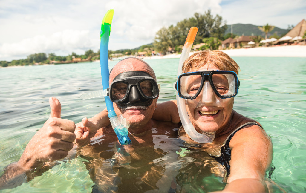 A couple wearing snorkels on a beach