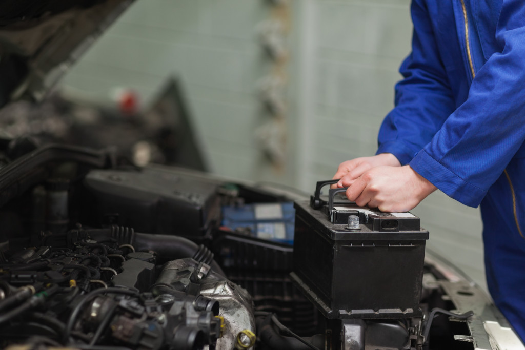 A mechanic replacing a car's battery