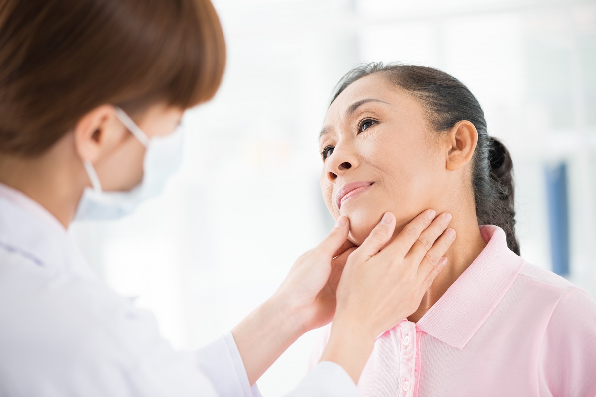 doctor checking lymph nodes of woman