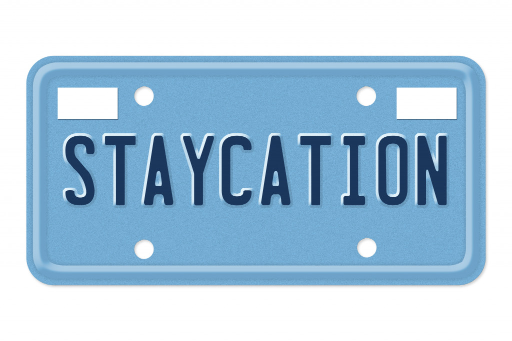 A blue sign with the word STAYCATION