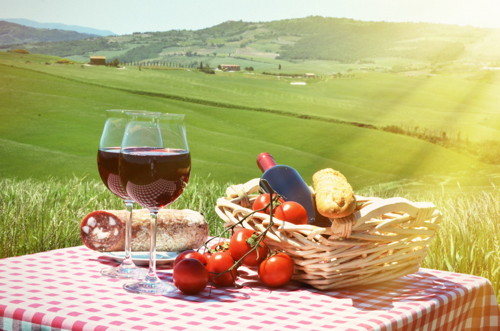 Picnic food in baskets and table at a field