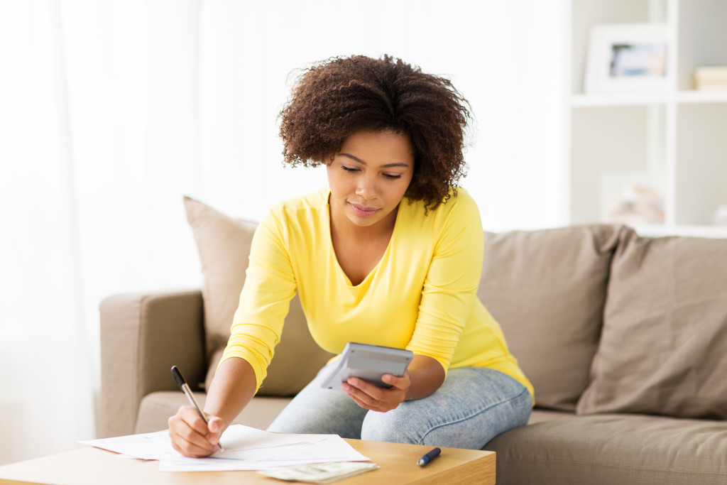 woman computing her taxes at home