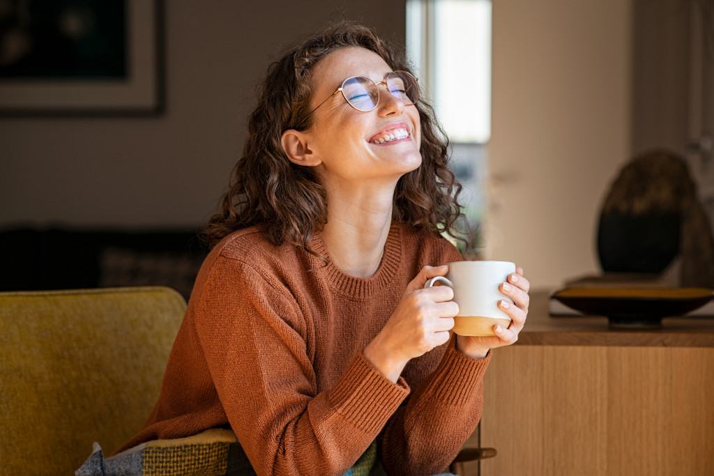 woman smiling drinking coffee