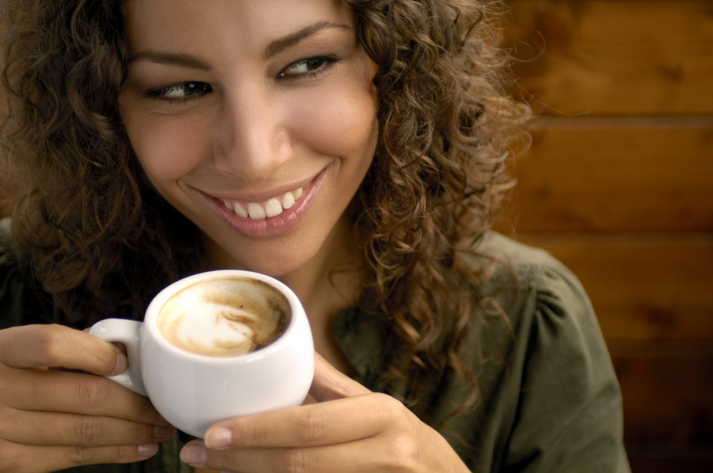 A woman enjoying cappuccino