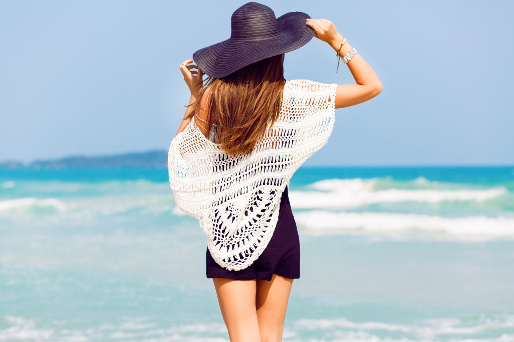 woman traveling with beach attire at the front of beach