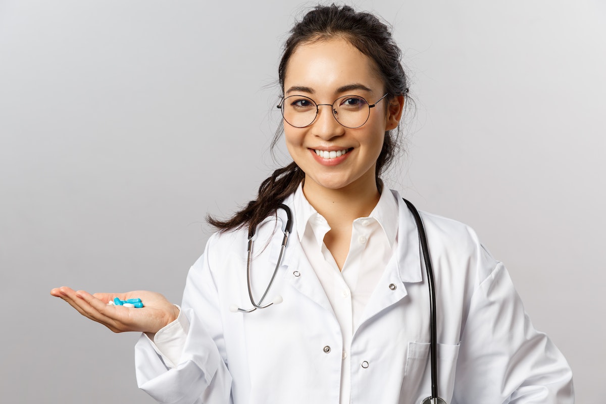 A Doctor Holding Blue Pills