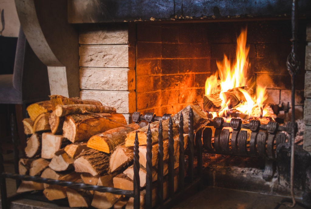 fireplace with logs on the side