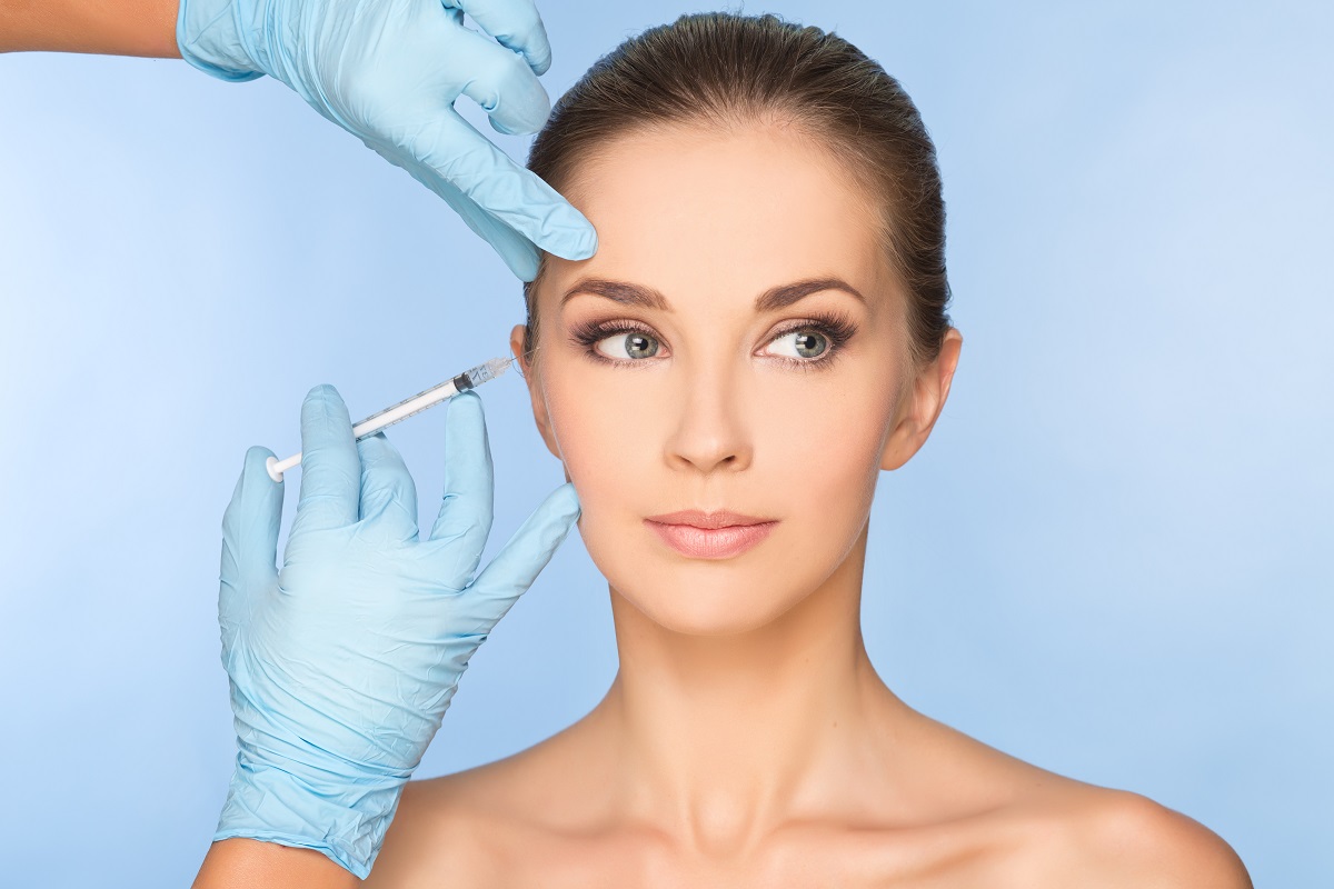 a woman getting a Botox from a doctor