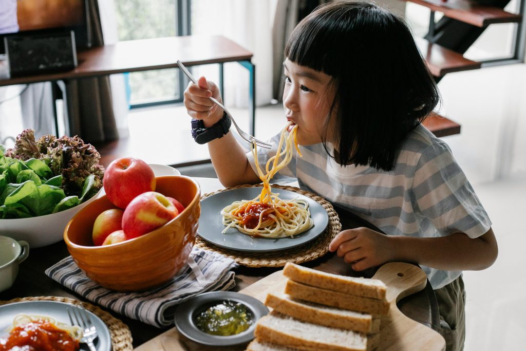 Girl eating spaghetti